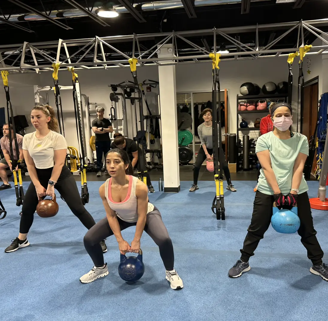 Group strength exercises with kettlebells at VIP Personal Fitness